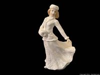 Front angle view of the Royal Doulton porcelain figurine showing details of the face, coat, and flowing skirt.