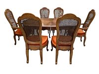 Rear view of table and six chairs showing cane backs and overall set layout