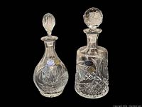 Front view of both Bohemia crystal decanters, highlighting shape and stoppers.