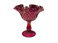 Side view showing hobnail texture and ruffled scalloped rim with ruby red coloration.