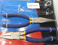 Two 8-inch pliers, needle nose and lineman style, with blue cushioned handles lying on packaging