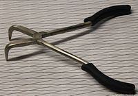 Bent needle nose pliers showing angled jaws and black handles on a white background.