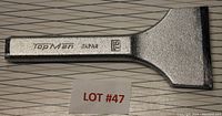 Flat metal chisel with branding 'Tap Man Japan 75' engraved on the handle, showing the full chisel including the blade edge.