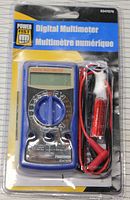 Front view of the Power Fist Digital Multimeter in original packaging showing the device with blue rotary selector and test leads coiled beside it.