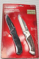 Photo of the two knives in original packaging showing Husky branding and product details.