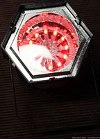 Close-up image of the LED strobe light showing red LEDs lit in a hexagonal housing.