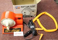 Orange raft air pump, yellow hose attachment, power cord with cigarette lighter plug, original box labeled KP Industries Model 98280.