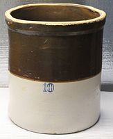 Full view of the 10 gallon stoneware crock showing its two-tone brown and white glaze with the number 10.