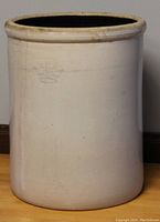 Full side view of the large stoneware crock showing its shape, size and surface condition.