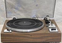 Front view with dust cover closed showing platter and control panels