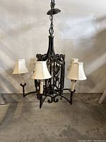 Full view of the 6-light antique chandelier showing the metal frame with removable beige fabric shades.