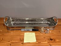 Full view of long silver serving tray showing rectangular shape with handles and surface condition