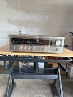 Front angle view of Onkyo TX-2500 vintage stereo receiver showing control knobs and tuning dial on a wooden table.