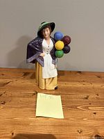 Full view of Royal Doulton Balloon Lady HN2935 figurine showing front and balloons.