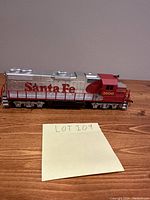 Side view of the vintage Santa Fe 3500 train engine showing lettering and detailing on a wood surface.