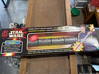 Original unopened box of Star Wars Episode 1 Darth Maul double-bladed lightsaber showing product details and packaging.