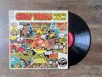 Vinyl LP record and colorful illustrated album cover for Cheap Thrills by Big Brother & The Holding Company.
