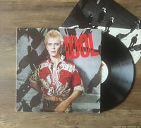 Photo of Billy Idol self-titled vinyl LP, showing album cover with Billy Idol in patterned shirt and the black vinyl partially pulled out.