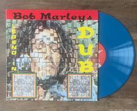 Blue colored vinyl LP record titled 'Bob Marley Legend in Dub' with album cover showing a pixelated photo of Bob Marley.
