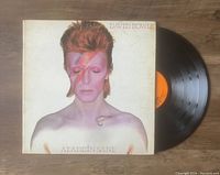 Front of vinyl LP record and album cover with David Bowie Aladdin Sane artwork