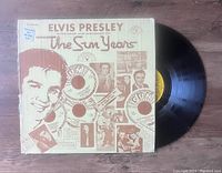 Vinyl LP record partially out of cover showing front cover art and record surface