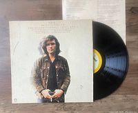 Vinyl LP record and cover of The Silver Tongued Devil And I by Kris Kristofferson. The record is partially out of the sleeve showing the yellow label.
