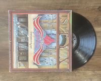 Photo of Styx Paradise Theatre vinyl LP with original cover and record partly out.