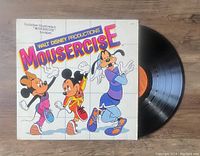 Photo of Mousercise vinyl LP record partially out of sleeve showing front cover illustration and vinyl surface.