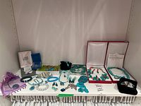 Shelf display showing various necklaces, bracelets and earrings