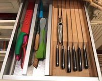 Drawer insert showing left compartment with five silicone and metal utensils