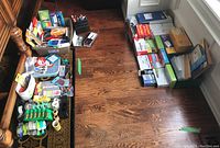 Full view of office supplies including assorted Scotch tapes, pens, highlighters, markers, letter openers, scissors, and various stationery items on the floor.