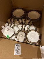 Photo of boxed Royal Doulton Cadenza china set showing cups, saucers, plates, and teapot lid