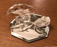 Photo showing both the Swarovski dolphin figure on mirrored base and the Mats Jonasson signed crystal fish figurine together.
