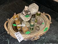 Full view of the ornate mirrored tray with all trinket boxes, decorative eggs, music box with bear figure, and small clock arranged on the tray