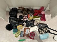 Overall lot view of assorted wallets, purses and bags