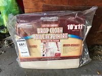 Photo showing the full packaged canvas drop cloth with Stain Pro branding, size 10'x11'.