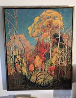 Full view of the large framed autumn tree print, showing colorful foliage and the dark frame.