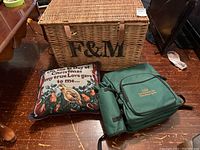 Wicker chest, Christmas cushion and green picnic knapsack set on wood floor