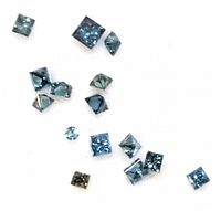 Close-up photo showing various loose blue diamonds of different sizes and shapes on a white background.