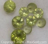 Close-up of multiple round-cut light green genuine peridot stones