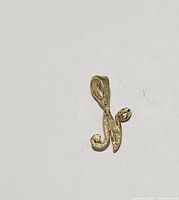 Close-up photo of the 10k gold pendant showing design and texture.