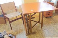 Table and chair displayed side by side, table fully open and chair to left.