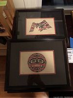 Two framed limited edition prints by Jim Johnny, one depicting a bird, the other a round face design, both with black frames and mats.