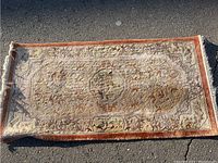 Full view of rectangular wool area rug showing overall pattern and color, some fading visible.