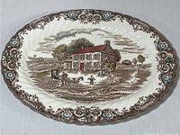 Full top view of the oval Johnson Bros ironstone platter showing the entire decorative scene and border