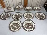 Photo of entire set including plates, bowls, covered butter dish, and divided serving dish with handle on white surface.