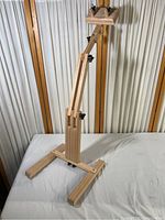 Full view of the maple utility quilting stand showing its upright adjustable structure, base, and locking knobs.