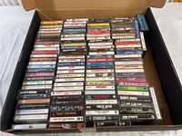 View of the full box collection of cassette tapes showing spine labels of various artists and albums.
