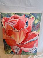Full view of acrylic painting of a large rose with multi-colored background