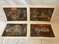Photo shows all four novelty dog prints laid out side by side, featuring dogs in card games and gambling scenes.